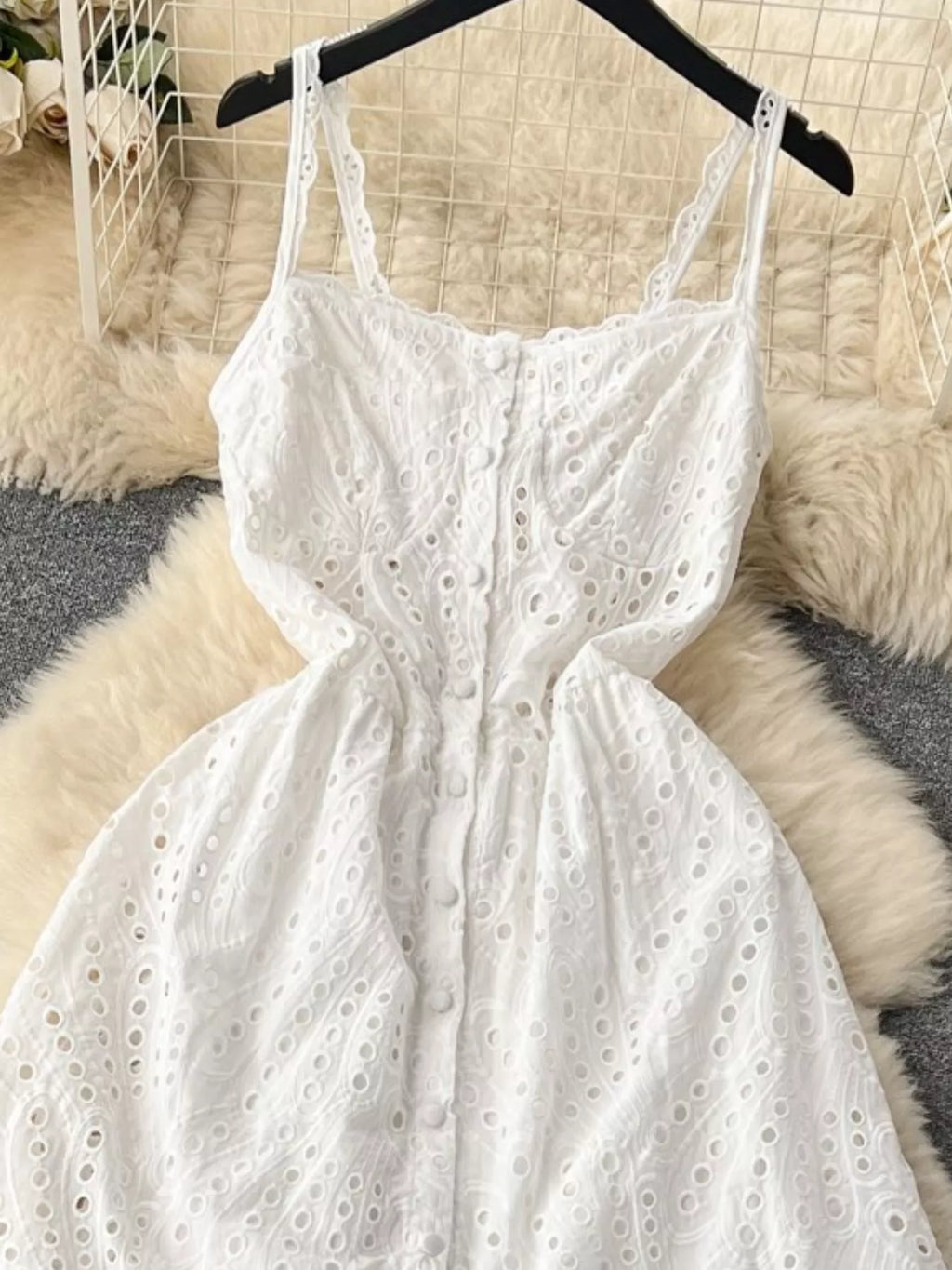 Eyelet embroidered tiered boho camisole summer midi dress with eyelet details and flowing fabric, perfect for warm weather.