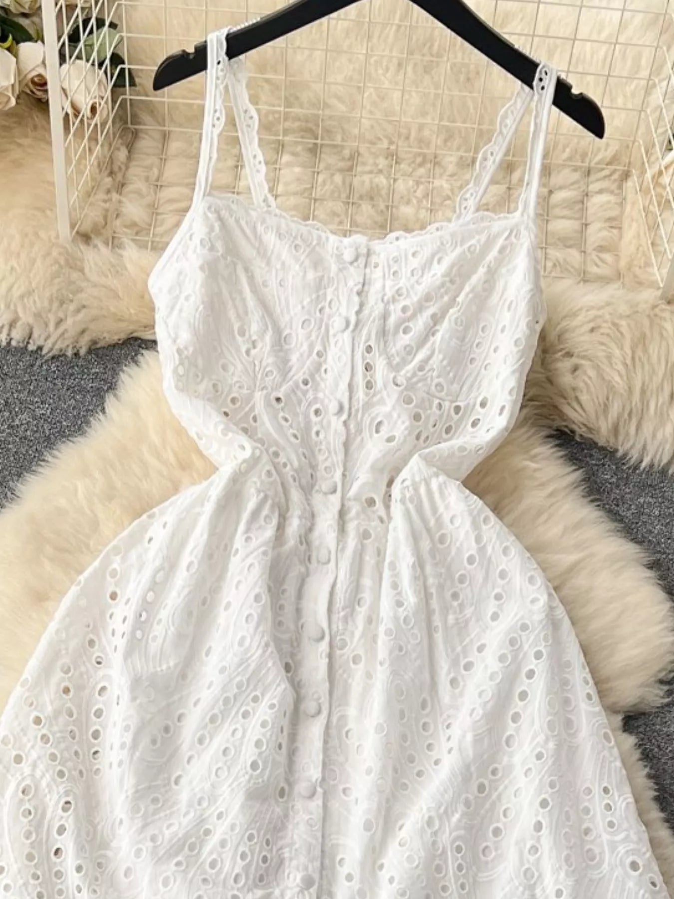 Eyelet embroidered tiered boho camisole summer midi dress with eyelet details and flowing fabric, perfect for warm weather.