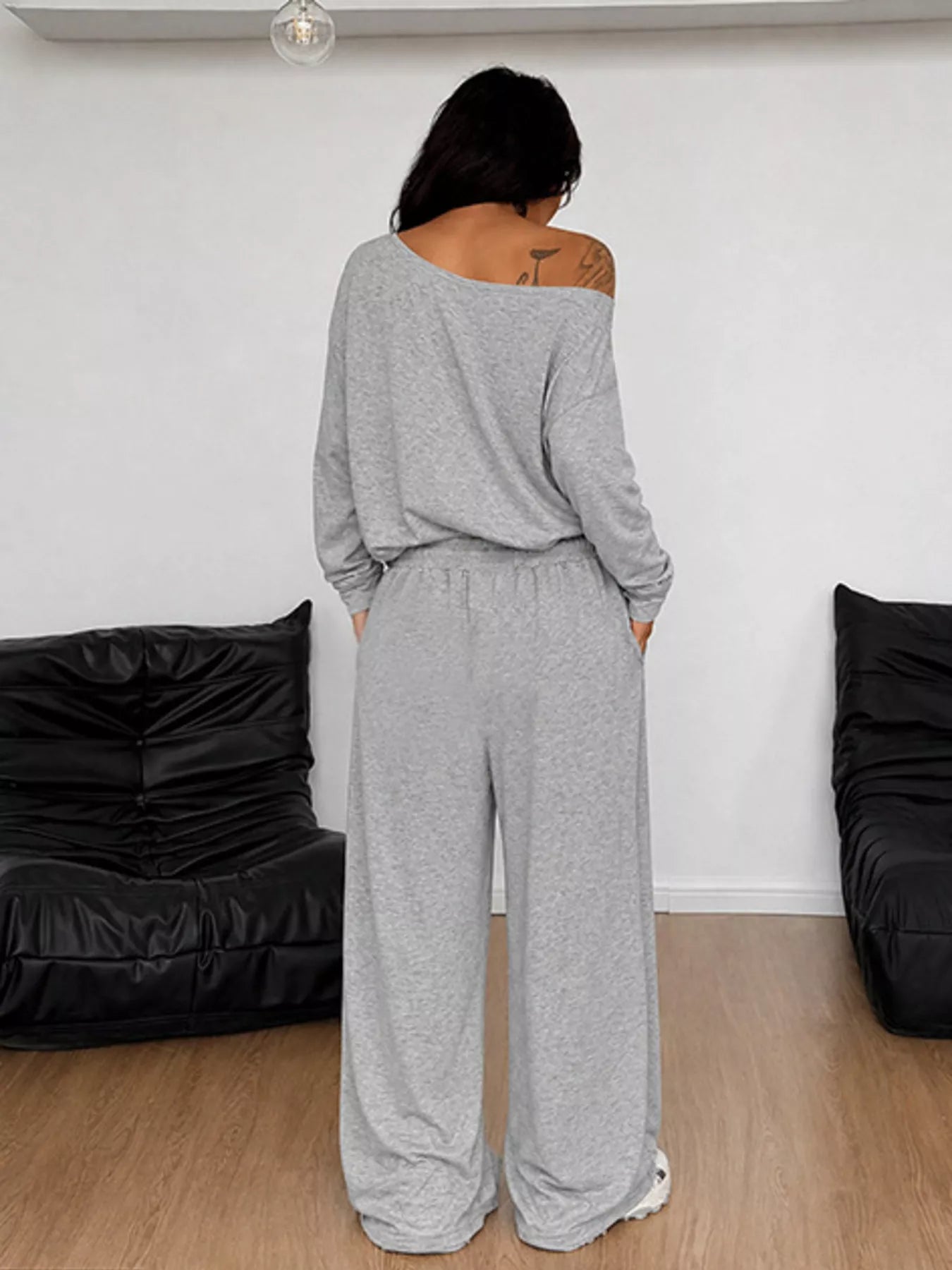 Plus size loose fit one-shoulder T-shirt and pants set by Trendsi, comfortable and stylish, with the focus on the pants and relaxed fit.