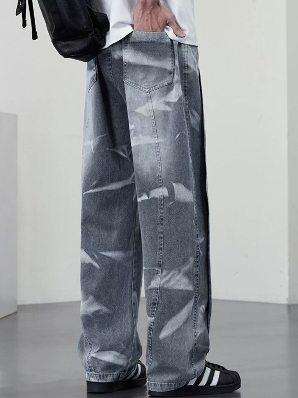 Men's plus size washed wide-leg jeans from Trendsi, showing the relaxed fit and faded denim fabric in a casual style.
