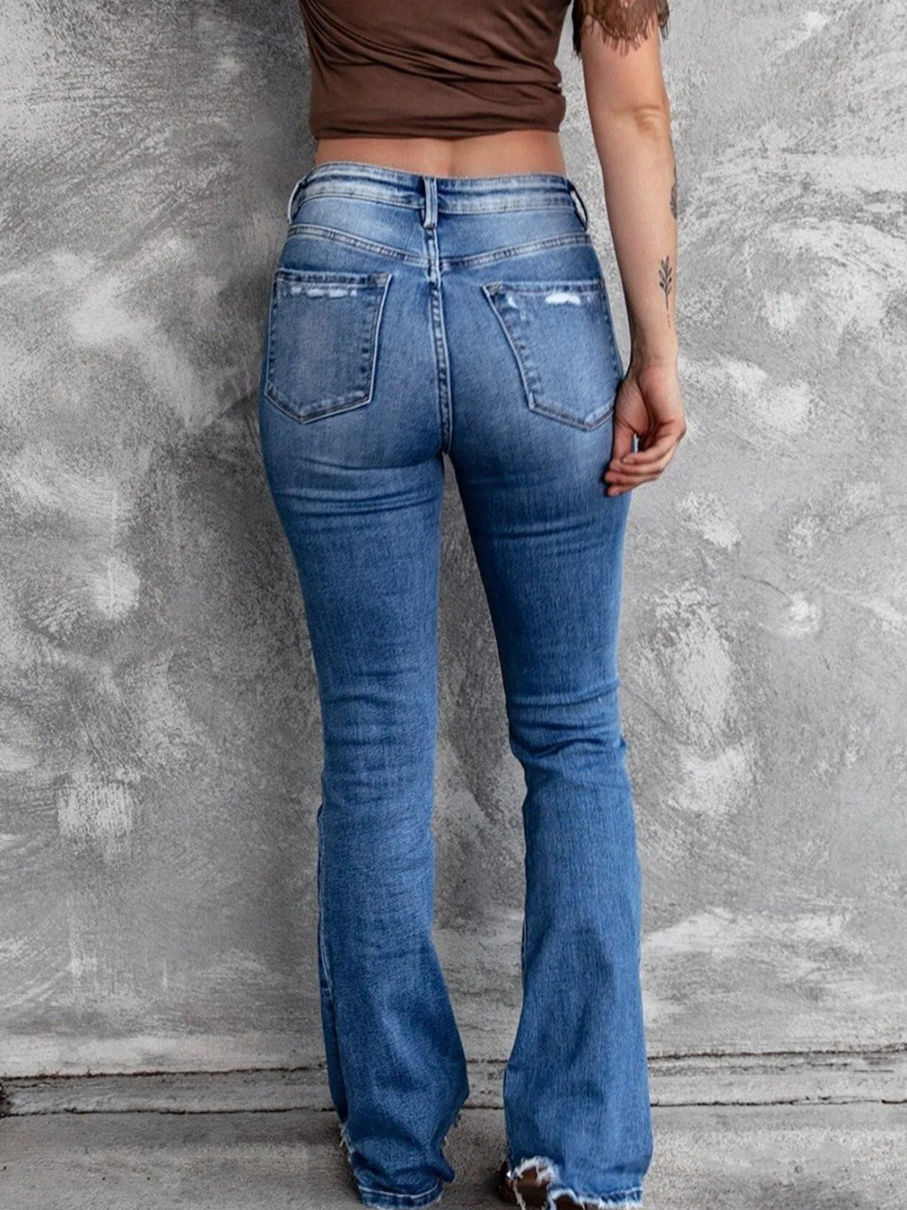 Distressed flare denim jeans by Plush Fashion Shop featuring ripped details and a fitted high-waist style.
