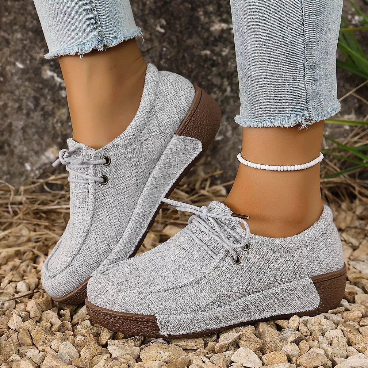 Close-up of white round toe lace-up sneakers from Trendsi showing the stylish footwear design and detailed laces.