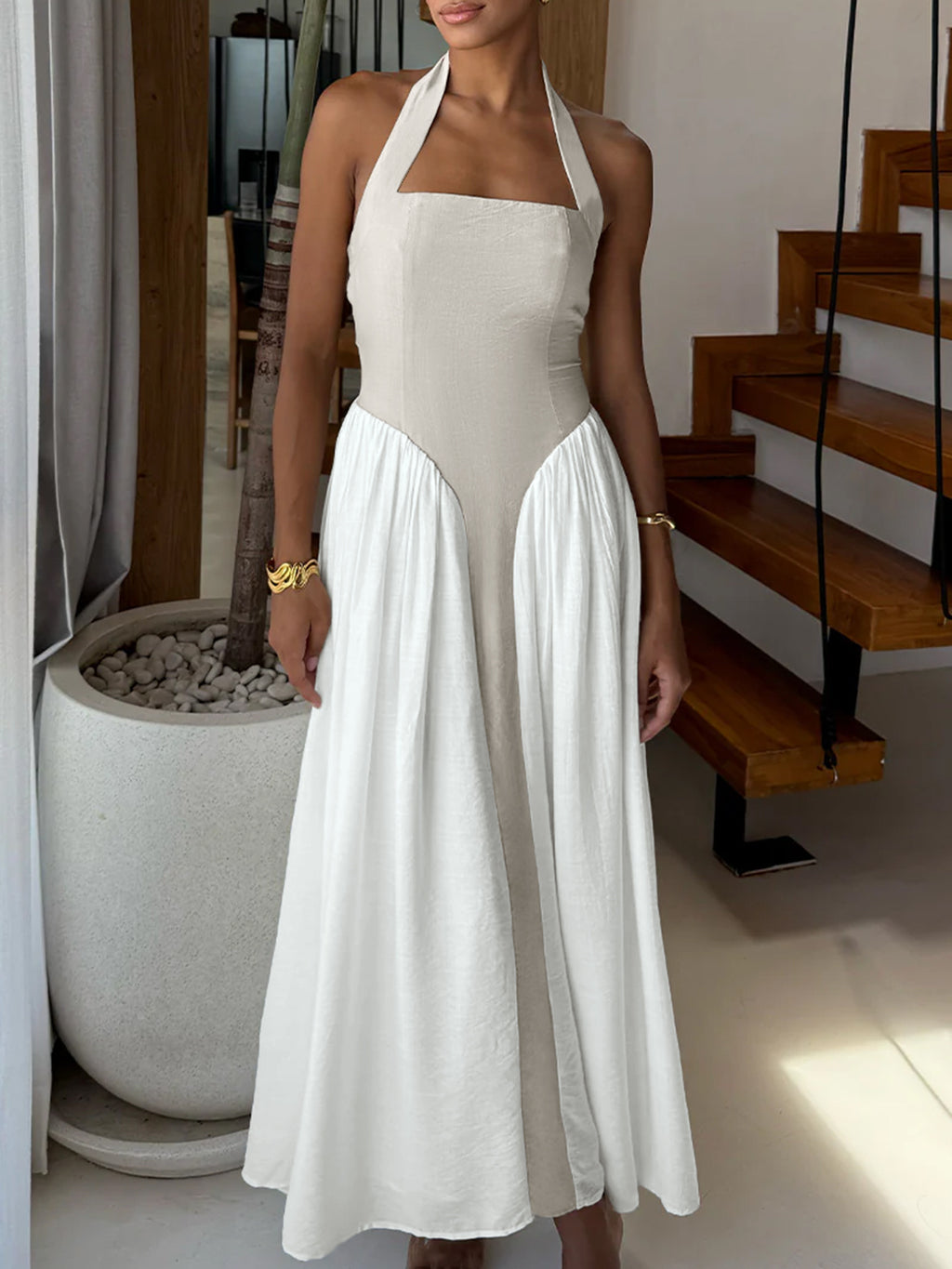 Elegant two-tone halter neck maxi dress by Plush Fashion Hub featuring ruched details and pockets, displayed on a model.