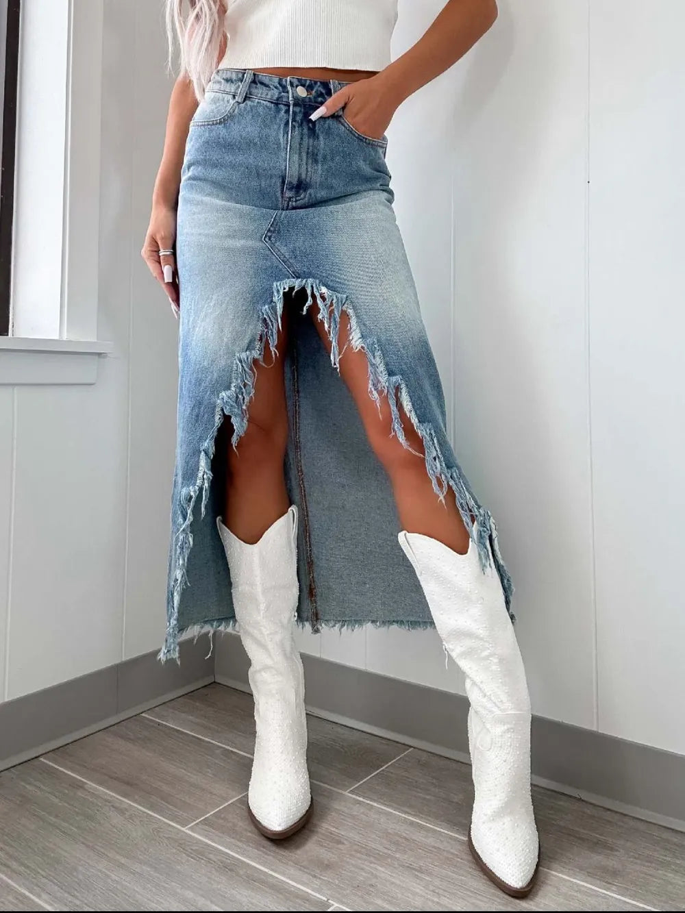 High-waist raw hem asymmetrical denim skirt by Trendsi, featuring distressed denim and uneven hem, perfect for casual stylish outfits.