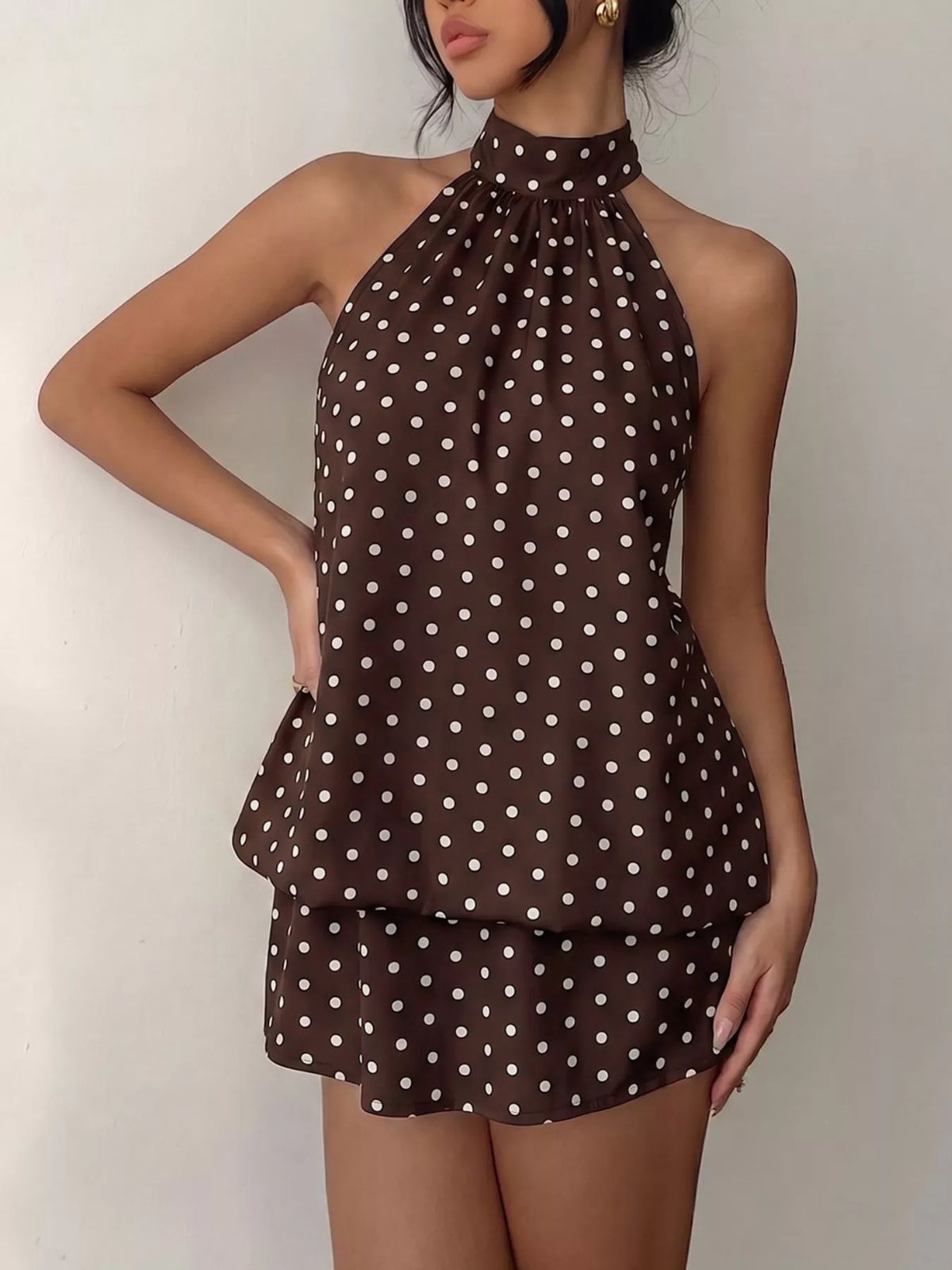 Polka dot halter neck mini dress by Plush Fashion Hub featuring a stylish design and a fitted silhouette.