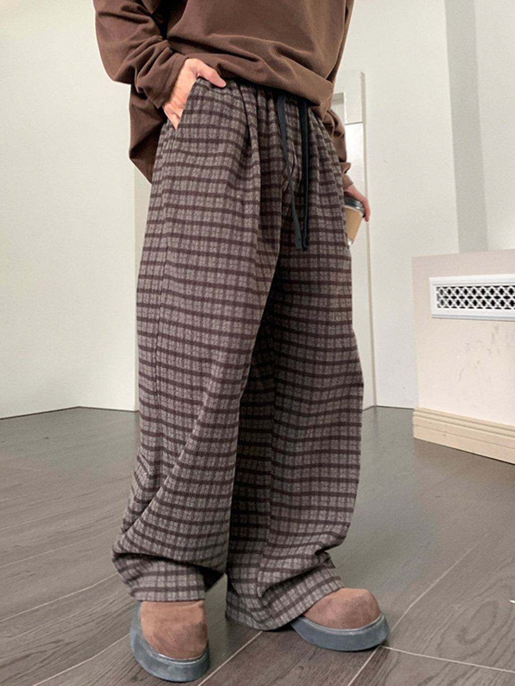 Men's plaid wide leg casual pants with drawstring waist by Trendsi, shown in a relaxed fit with a stylish plaid pattern.