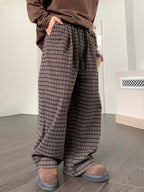 Men's plaid wide leg casual pants with drawstring waist by Trendsi, shown in a relaxed fit with a stylish plaid pattern.