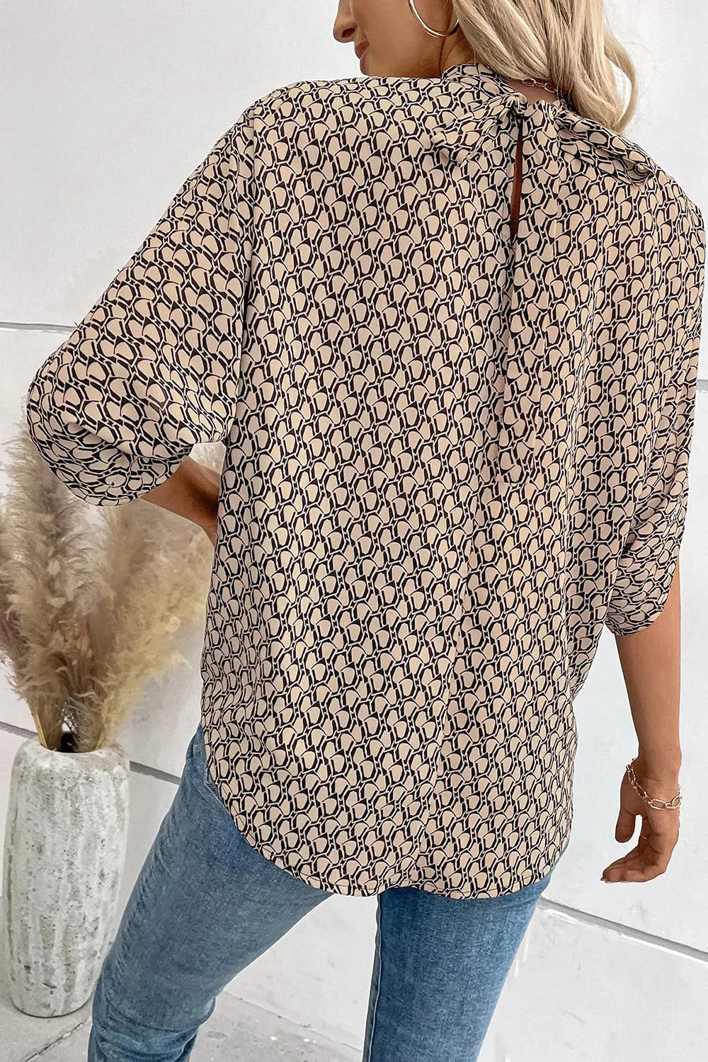 Elegant Plush Fashion Hub tie-back half-sleeve blouse with side slit, stylish tops featuring a flattering fit and sophisticated design.