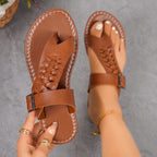 Plush Fashion Hub toe loop flats sandals featuring a minimalist design with open toes and comfortable straps.