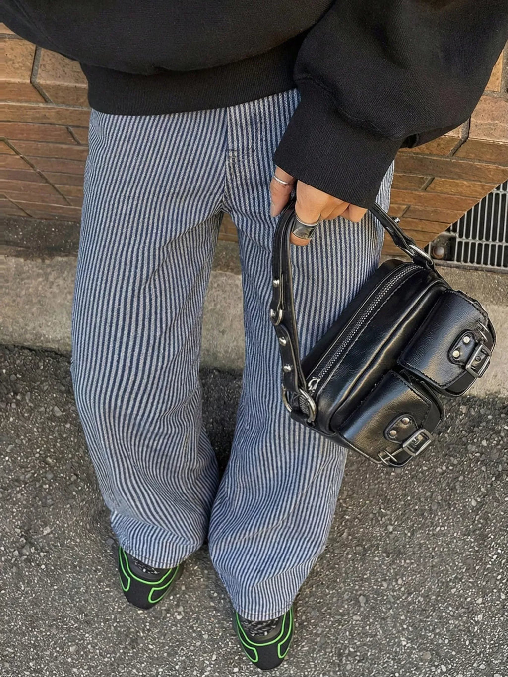 Striped wide-leg jeans by Shopimist featuring bold vertical stripes and a relaxed fit, shown on a model standing outdoors.