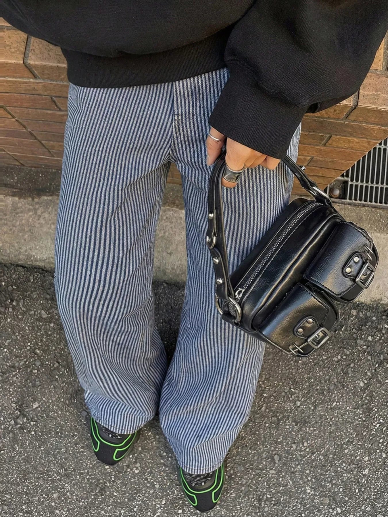 Striped wide-leg jeans by Shopimist featuring bold vertical stripes and a relaxed fit, shown on a model standing outdoors.
