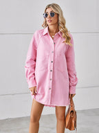 VYSN raw hem button-up denim dress displayed on a hanger, showcasing its casual style and distressed hem detail.