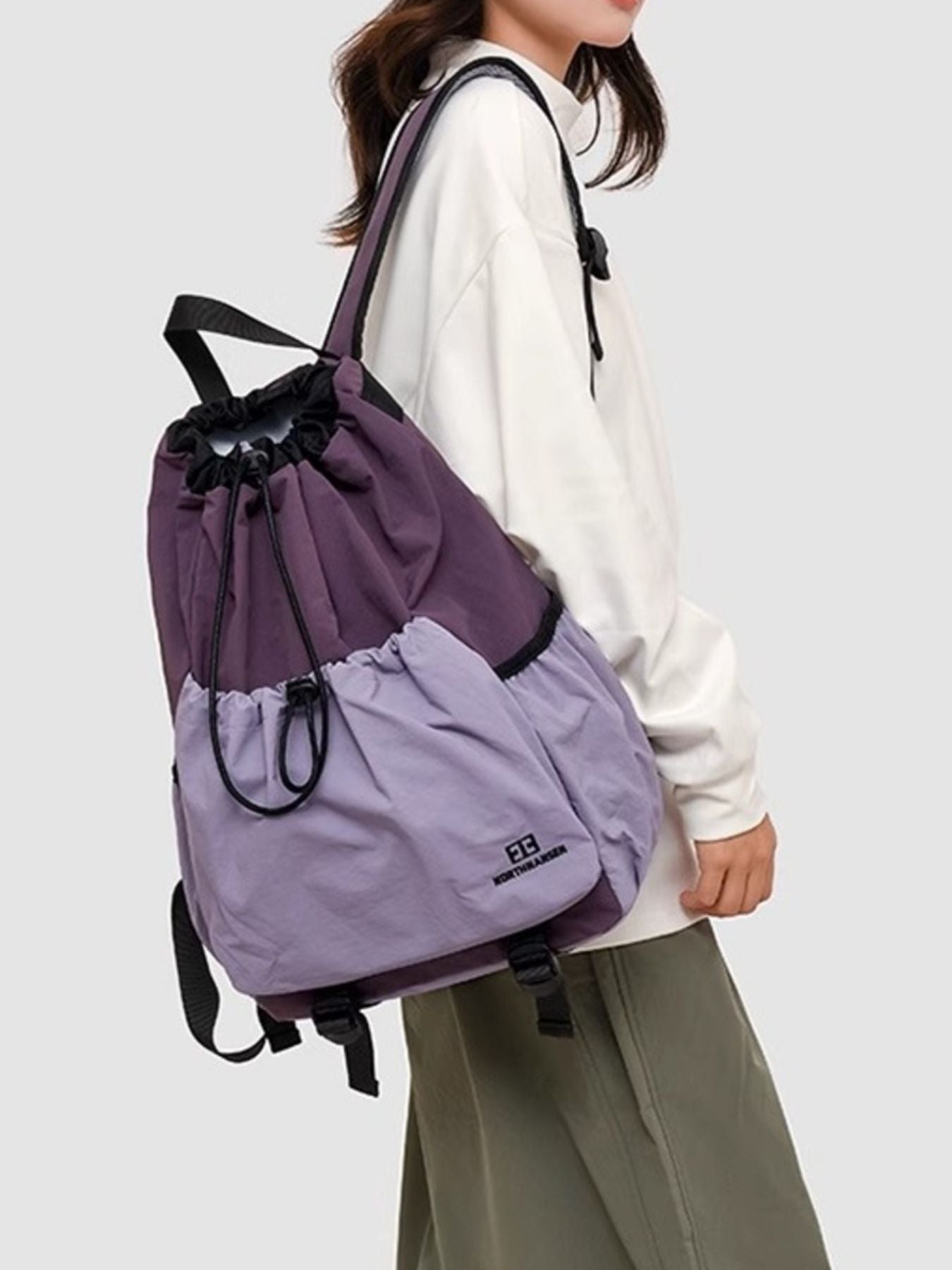 Lightweight nylon drawstring backpack by Trendsi, minimalist travel bag for women, showing the black nylon material and drawstring closure.