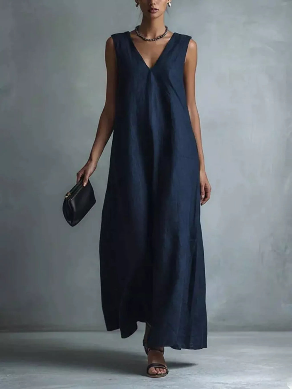Plus size full-length V-neck sleeveless maxi dress by Trendsi, flowing fabric and elegant design for a stylish look.