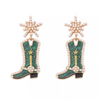 Cowgirl boot dangle earrings from Shopimist featuring Western-style boot charms hanging from hooks.