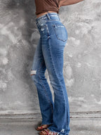 Distressed flare denim jeans from Plush Fashion Shop featuring ripped details and a high-waist fit, styled with casual footwear.