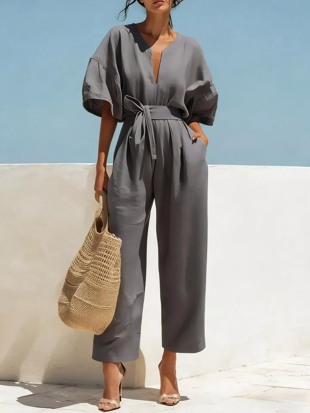 Trendsi tie waist wide-leg bodysuit with scoop neckline and long sleeves, displayed on a mannequin, in a neutral color.