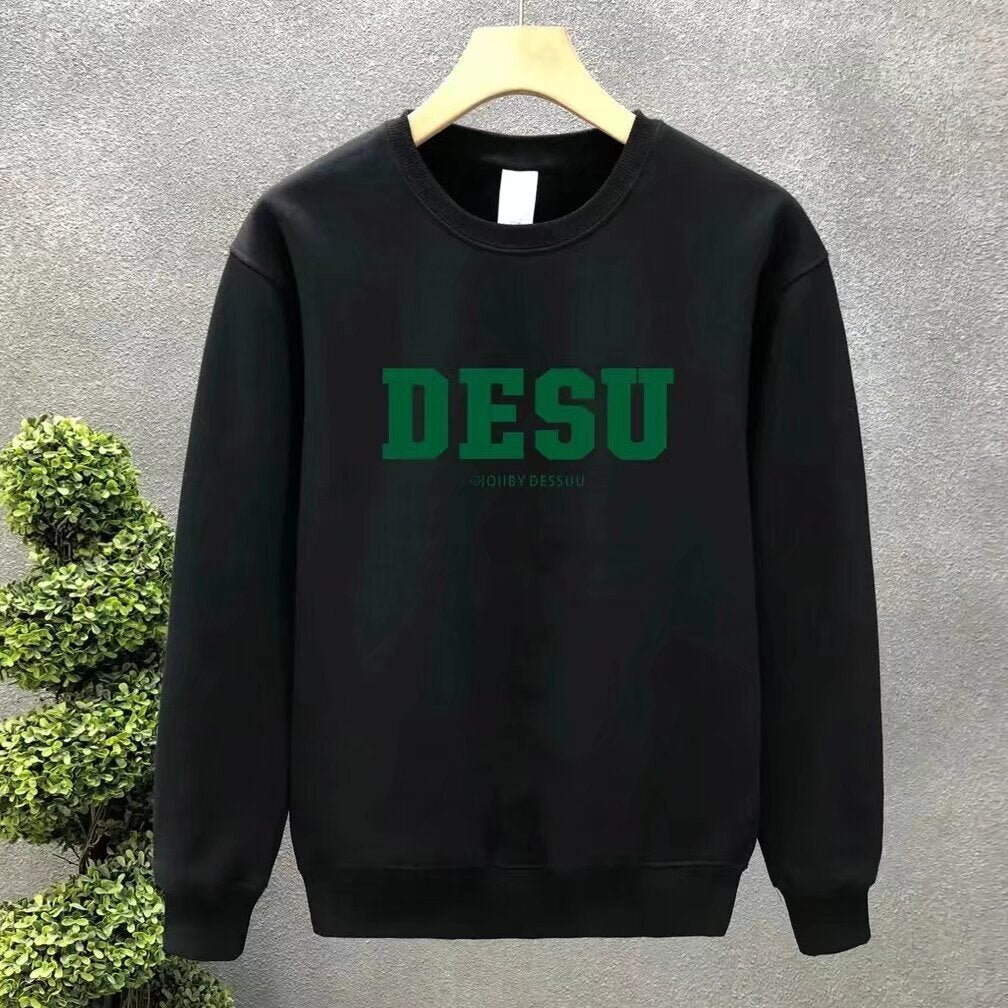 Black crewneck sweatshirt in a cotton blend with bold green "DESU" lettering across the chest.