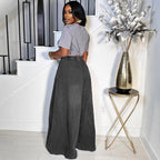 Relaxed, wide-leg charcoal grey denim jeans with a high-rise elastic waistband, styled with a grey acid-wash t-shirt.
