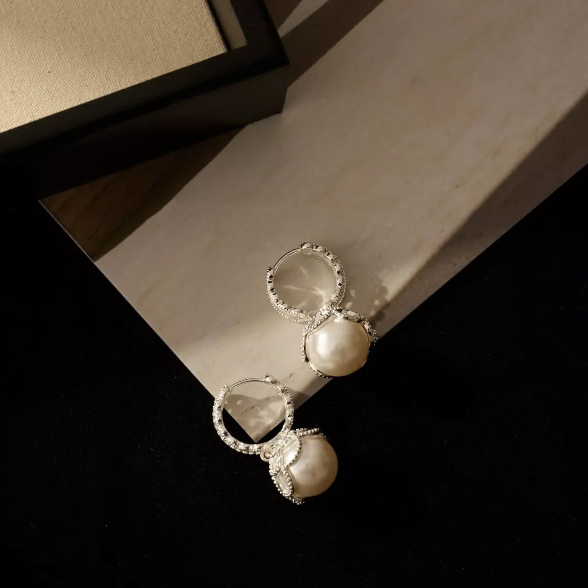 Pearl hoop earrings with zircon accents from Plush Fashion Hub, showcasing elegant jewelry with shiny pearl and sparkling stones.