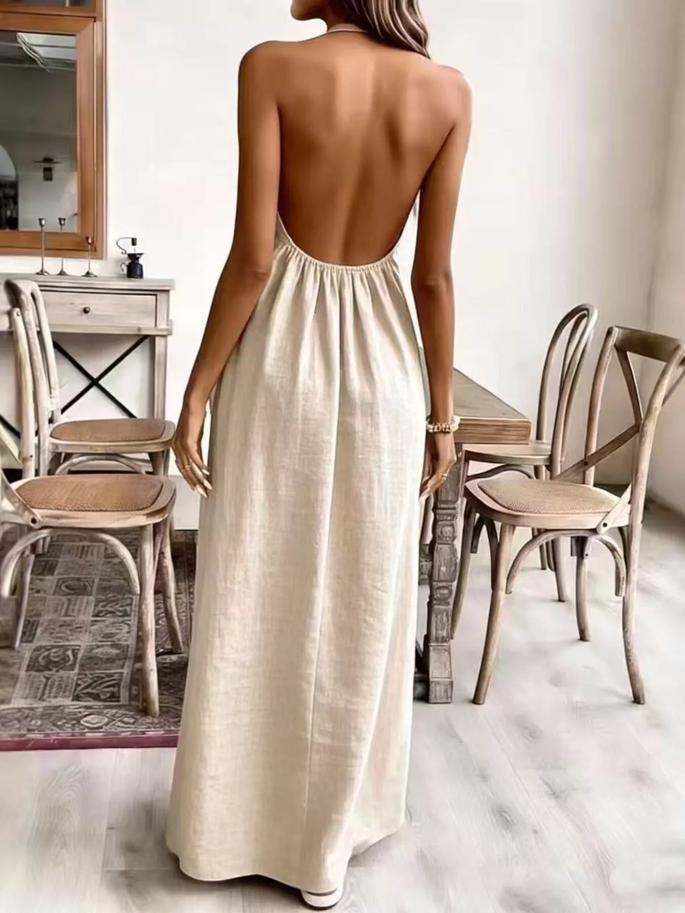 Plush Fashion Hub halter neck maxi dress with flowing fabric and open back, perfect for elegant summer occasions.
