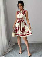 Sleeveless ruched printed tie waist dress by Shopimist, showcasing a vibrant floral pattern and gathered fabric at the waist.