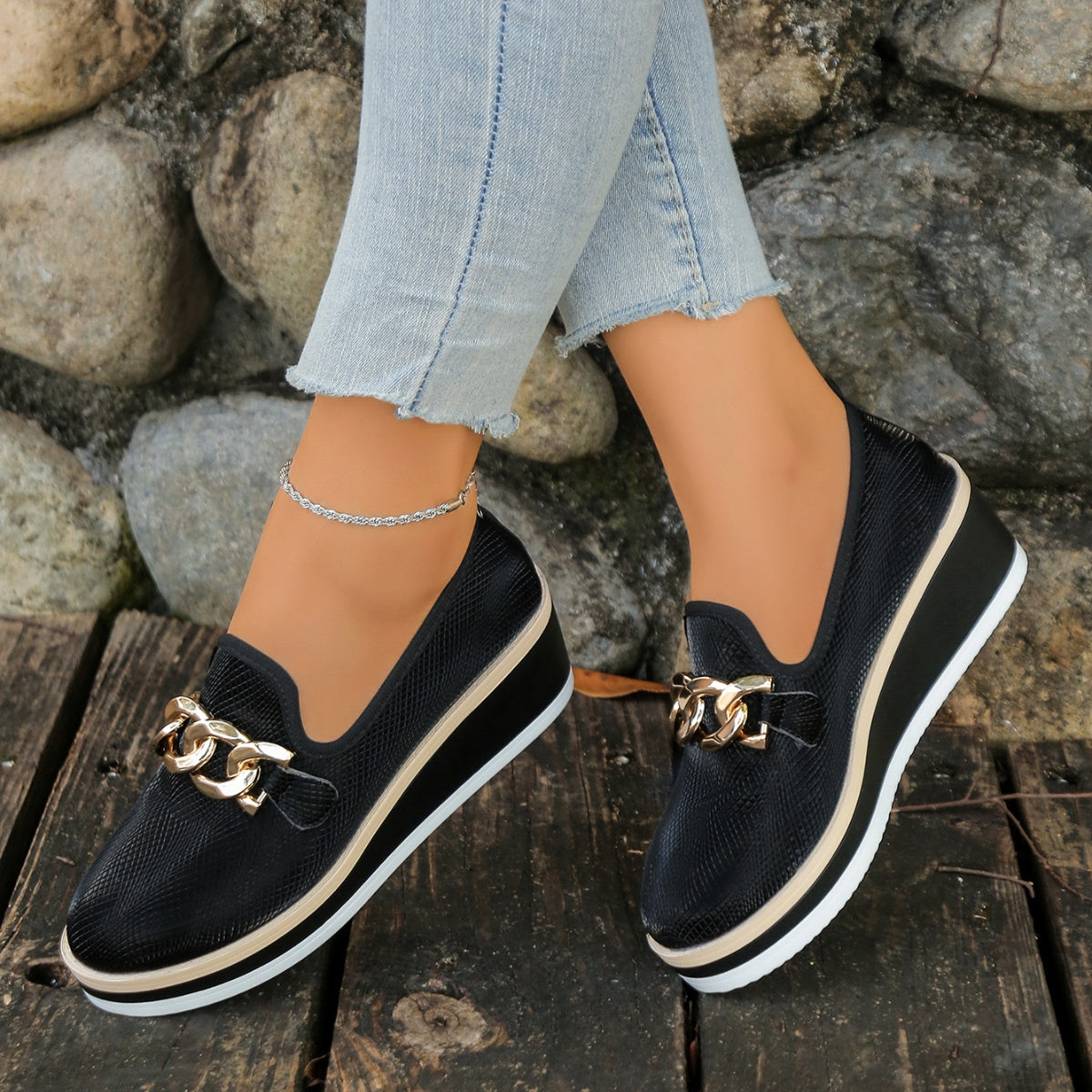 Chain decor wedge loafers by Trendsi featuring stylish footwear with a woven wedge heel and chain embellishment.