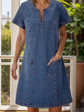 VYSN full size notched short sleeve denim dress hanging on a hanger, showcasing the casual fashion style and design details.