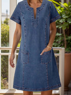 VYSN full size notched short sleeve denim dress hanging on a hanger, showcasing the casual fashion style and design details.