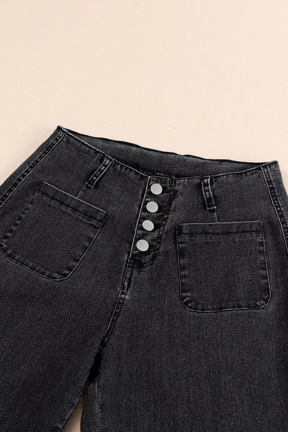 High-waisted button-fly wide-leg jeans by Trendsi, featuring a classic denim look with relaxed fit and stylish design.