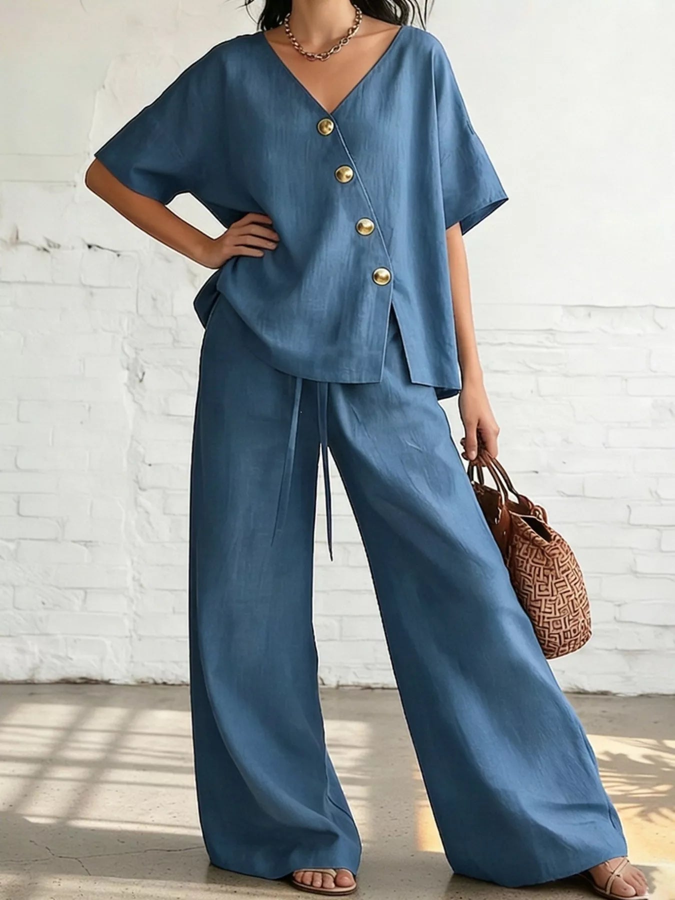 Plus size full surplice half sleeve top and wide-leg pants set by Trendsi, featuring a stylish, comfortable matching outfit.