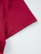 Women's fitted one-shoulder T-shirt with button accents, stylish and trendy from Trendsi, shown in a close-up view.