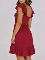 Women's smocked ruffle hem mini dress by Trendsi, casual lightweight summer dress with a fitted bodice and flowy ruffle hem.
