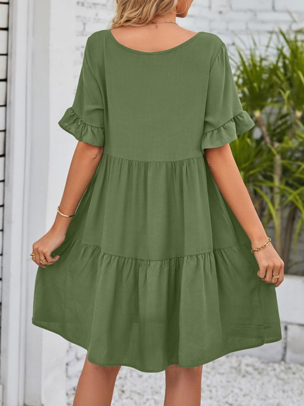 Lightweight rayon mini dress with ruffled sleeves, tiered design, and pockets, perfect for casual summer wear.