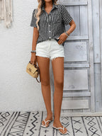 Women's lightweight plaid button-up short sleeve shirt by Trendsi, featuring a classic pattern and casual fit.