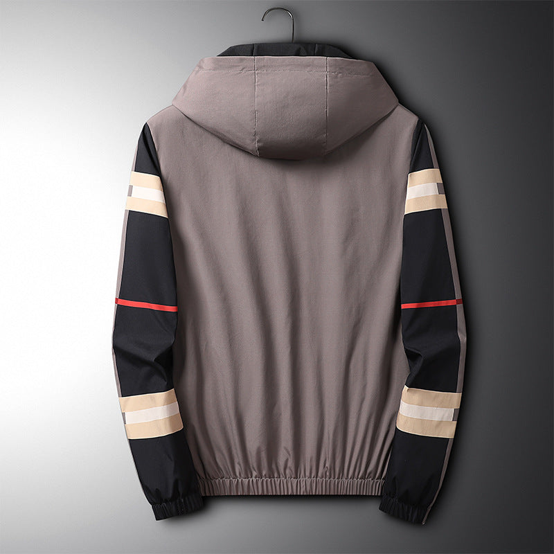 Back view of a taupe, black, and red nylon hooded jacket with striped sleeves on a hanger.