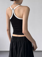 Contrast trim cami top from Trendsi, featuring a stylish sleeveless design with contrasting neckline and armhole details.