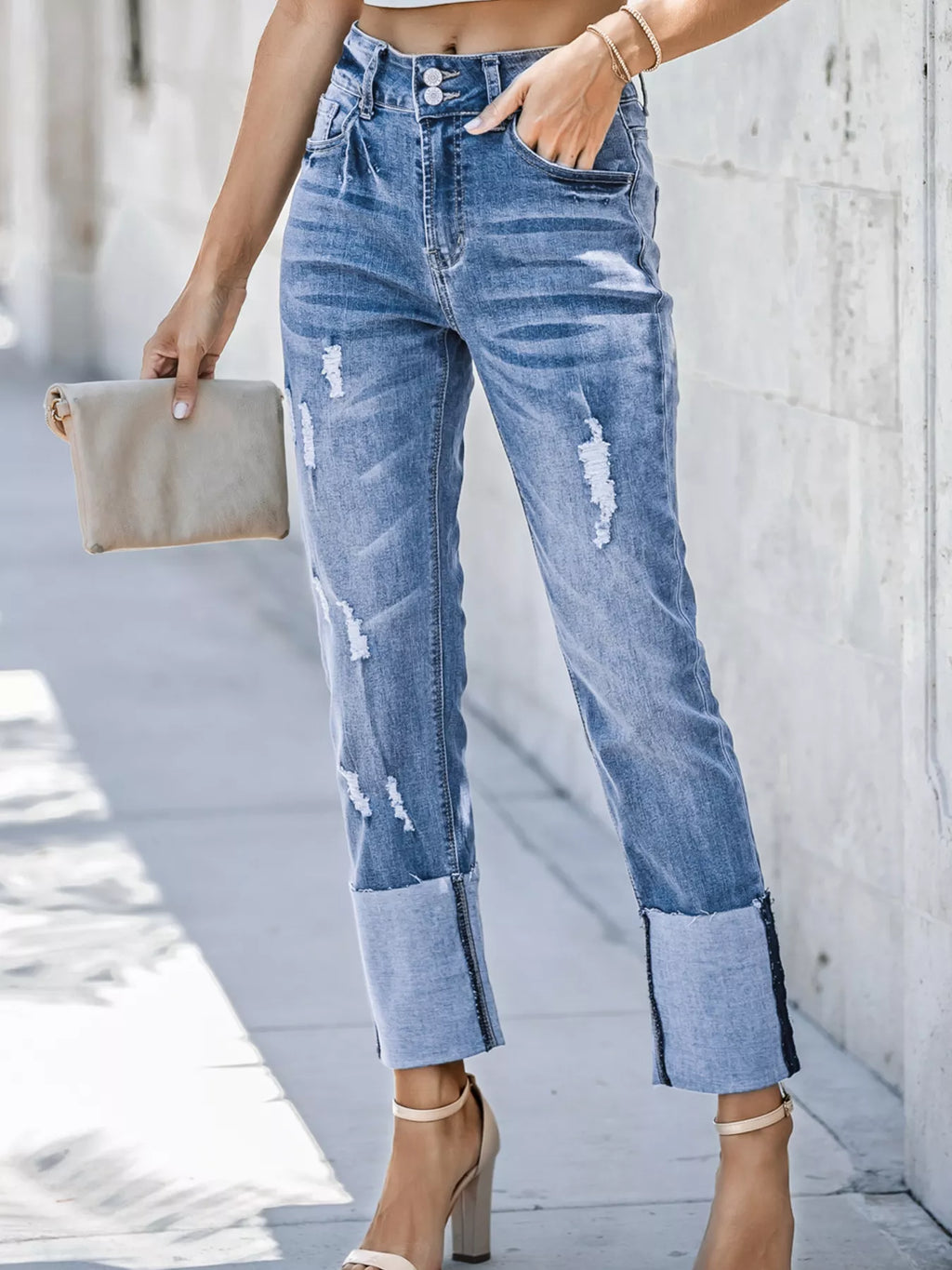 High waist distressed straight leg jeans by Trendsi, showing a close-up of the light wash denim with ripped details.
