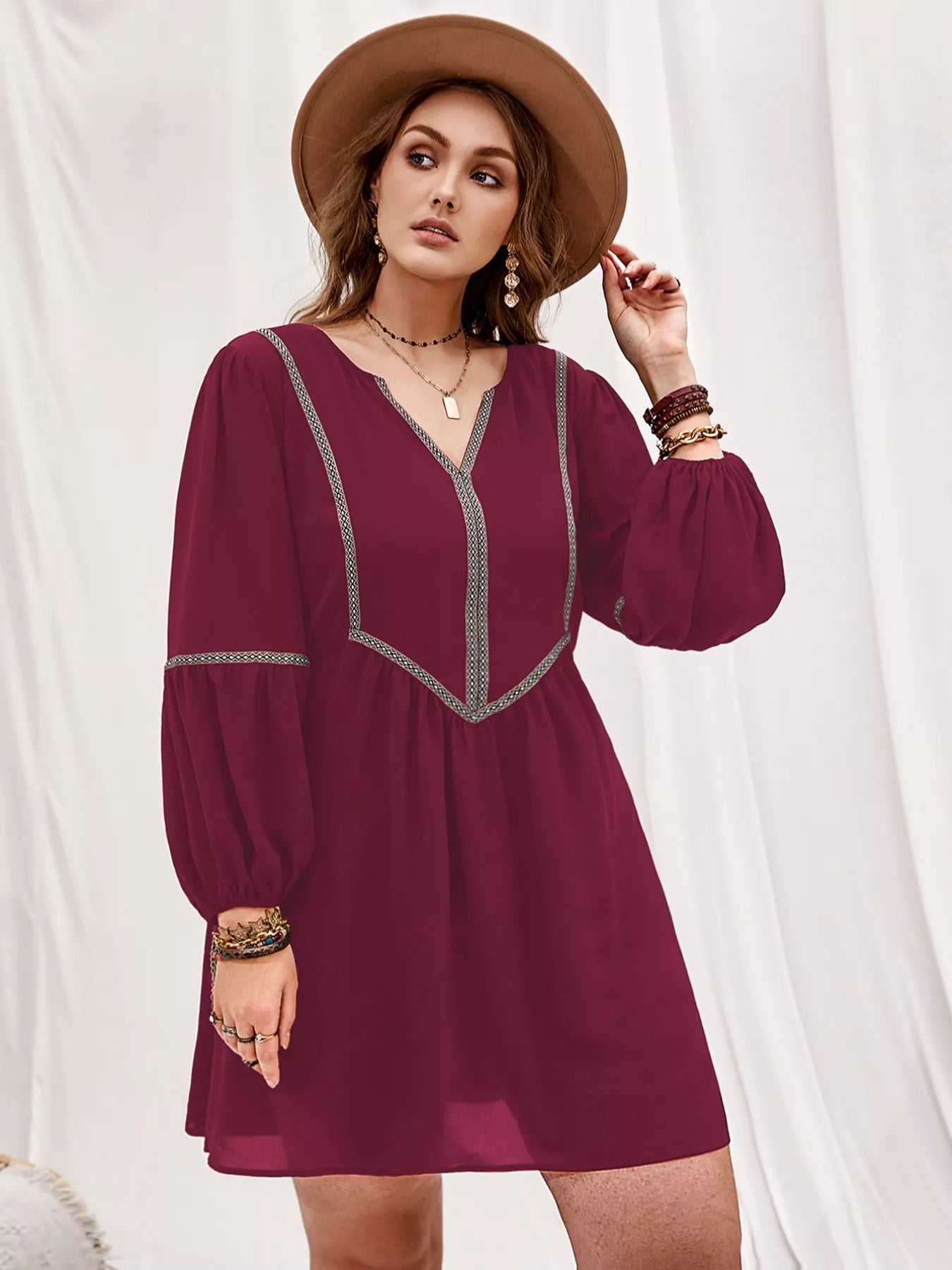 Plus size notched balloon sleeve mini dress by Shopimist featuring a stylish design and comfortable fit, shown on a model.