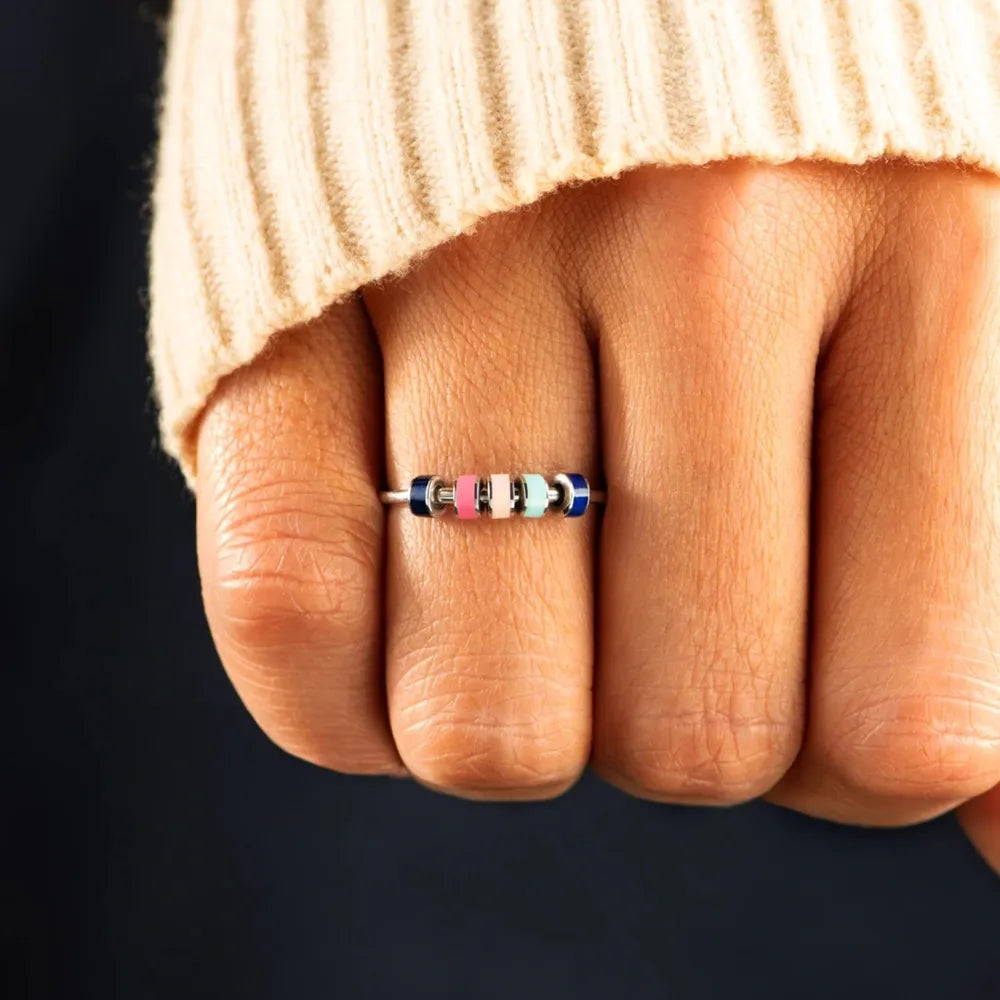 Sterling silver oil drip ring with smooth, shiny finish, showcasing a modern design in a close-up image.