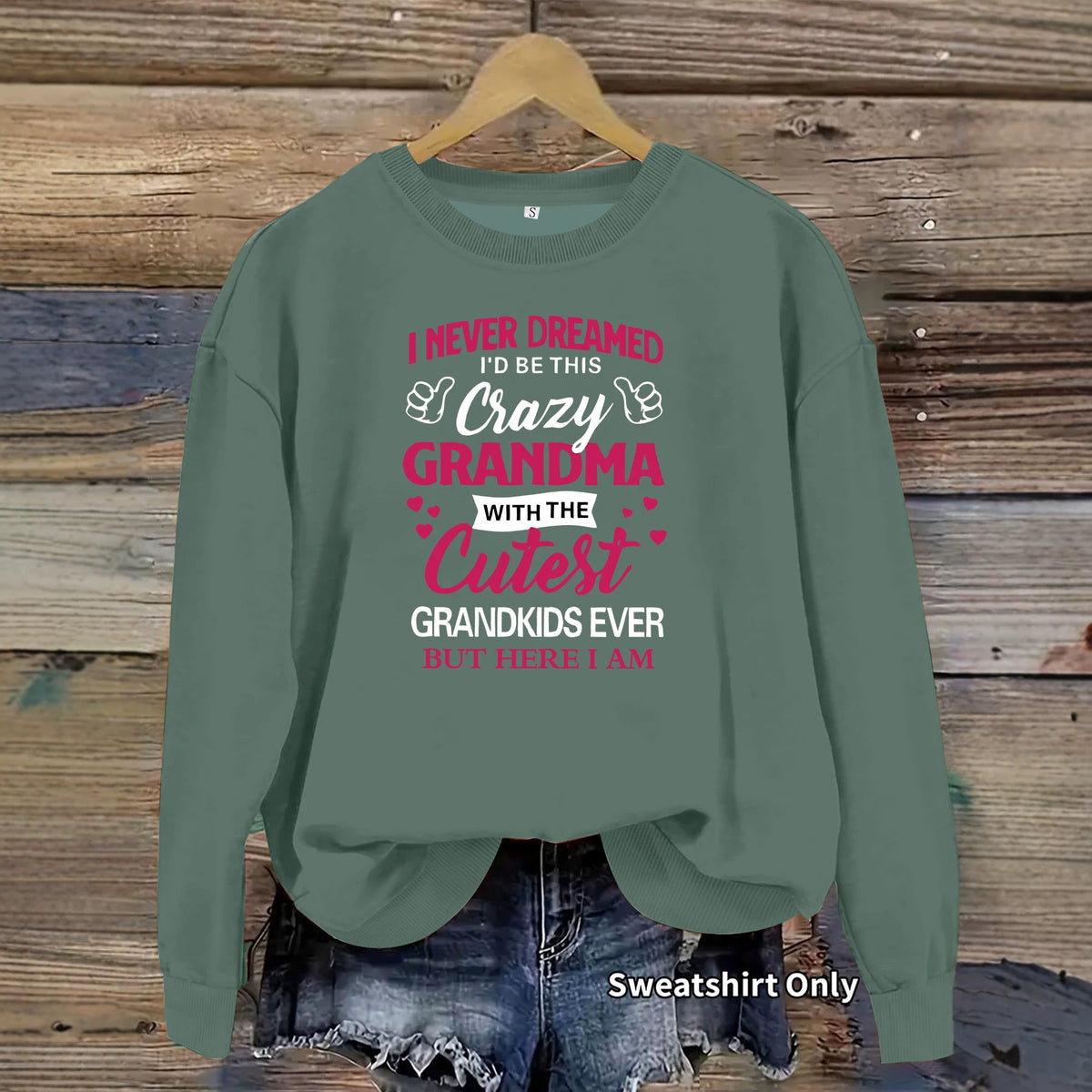 Sage green cotton crewneck sweatshirt with "Crazy Grandma" text graphic on the chest.