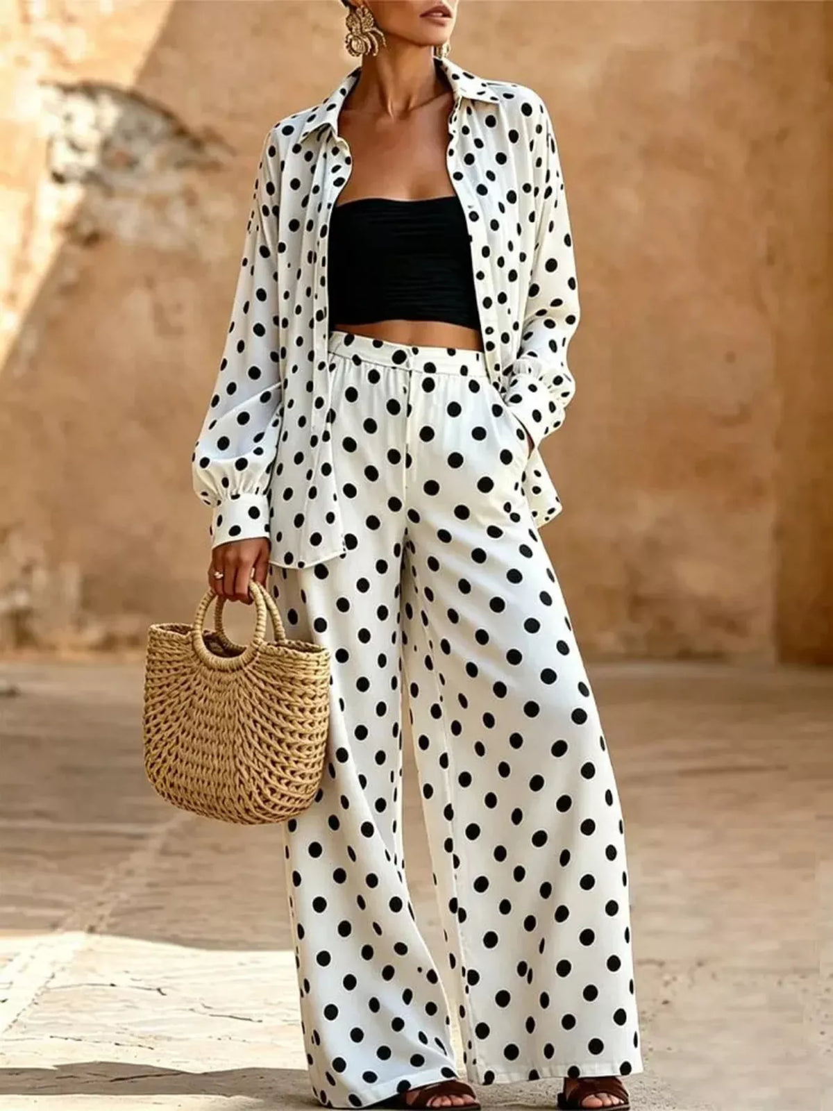 Plus size polka dot shirt and wide-leg pants set by Trendsi, featuring a stylish, coordinated outfit with bold polka dot pattern.