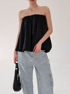 Women's strapless bubble hem tube top by Plush Fashion Hub, featuring a sleek, minimalist design and trendy crop style.