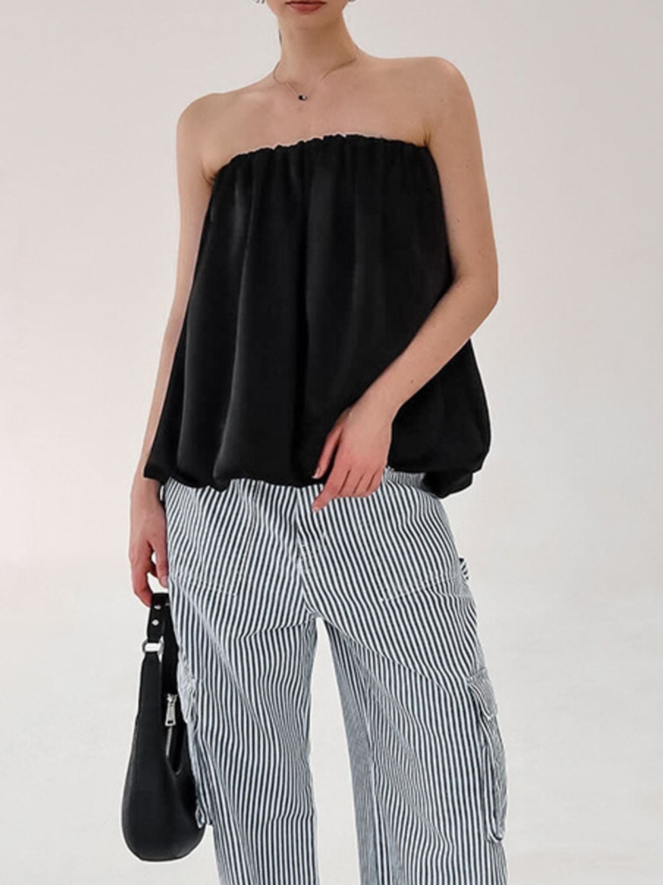 Women's strapless bubble hem tube top by Plush Fashion Hub, featuring a sleek, minimalist design and trendy crop style.
