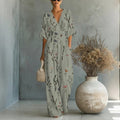 Women's waist-cinched V-neck printed wide-leg jumpsuit by FitiqueFit, featuring a casual style with a fitted waist and flowing legs.