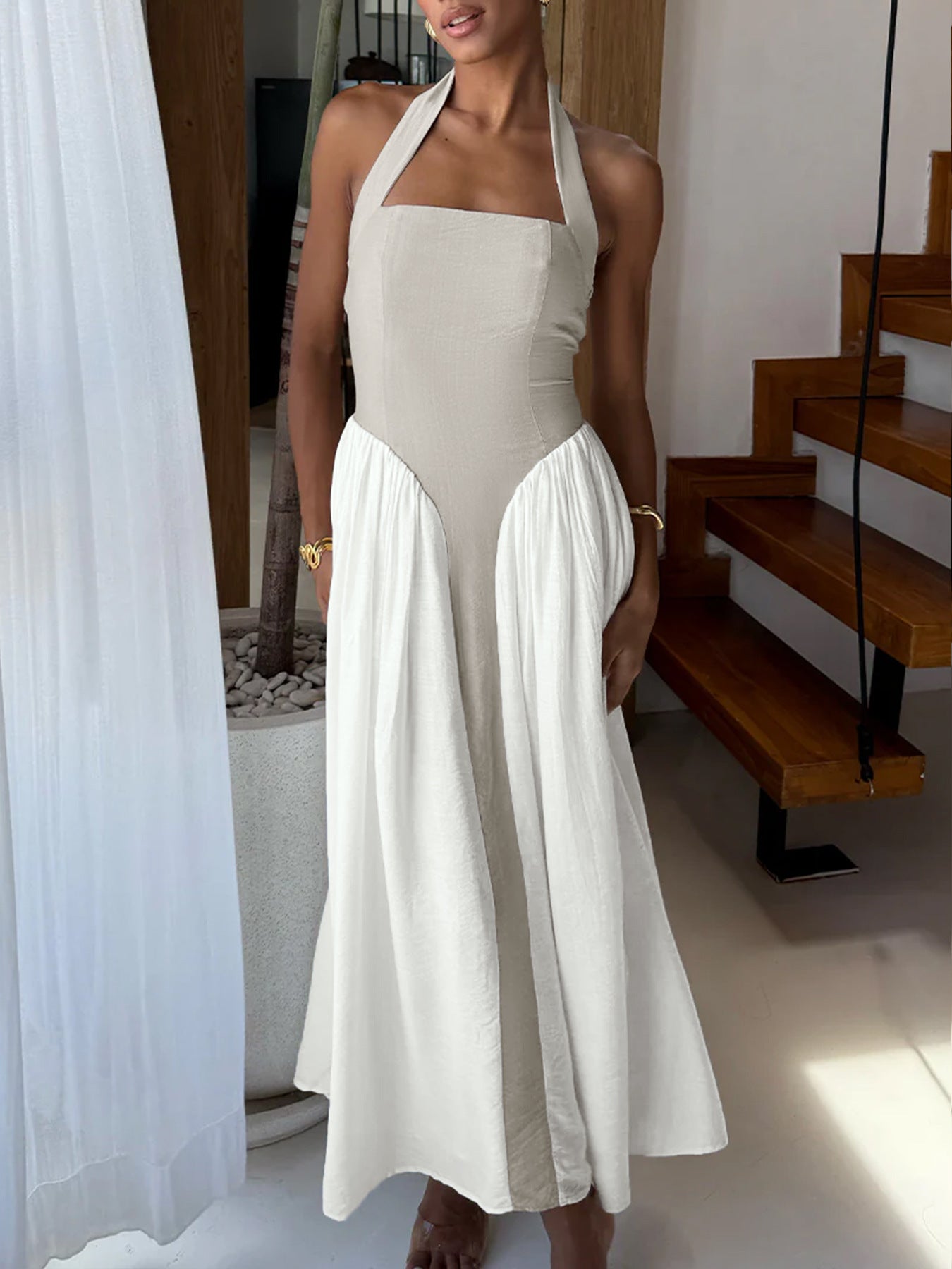Elegant two-tone halter neck maxi dress with ruching and pockets by Plush Fashion Hub, shown in a flowing fabric design.