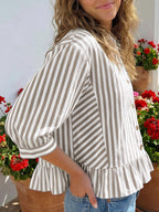 Women's striped button-down blouse with ruffled hem, lightweight viscose fabric, featuring long sleeves and a relaxed fit.