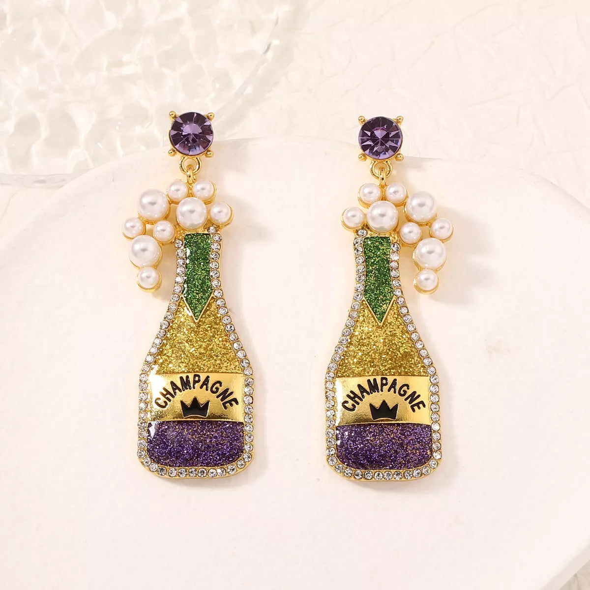 Champagne bottle earrings with pearl accents from Plush Fashion Hub, stylish jewelry featuring gold-tone charms and elegant design.