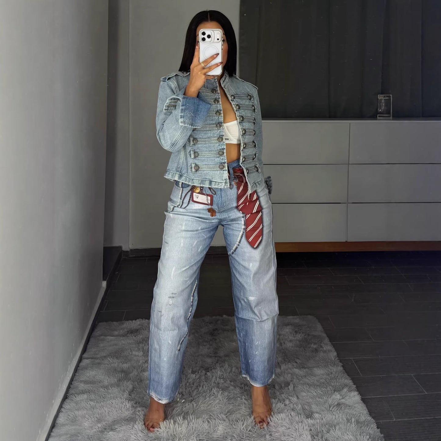 Eprolo street style badge print dagger jeans featuring bold graphic designs and a modern fit, shown in a close-up view.