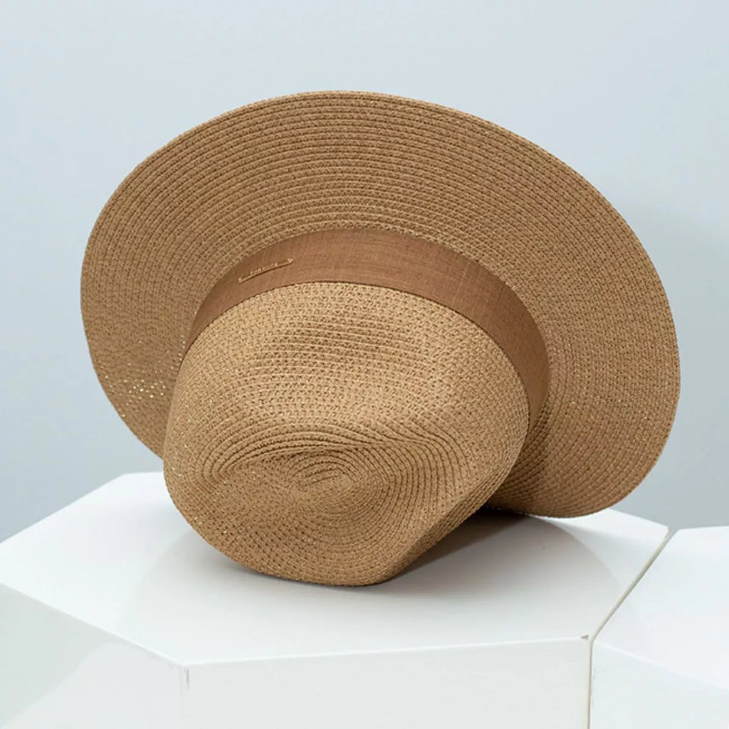 Women's wide brim straw sun hat by Plush Fashion Hub, featuring a classic summer beach accessory with a stylish, wide brim design.